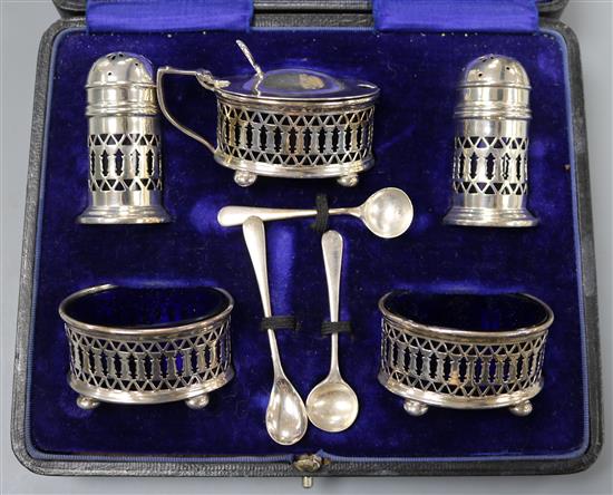 A cased pierced silver five piece condiment set, Birmingham, 1915.